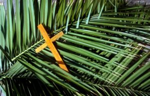Wooden cross on palm leaves, Palm Sunday